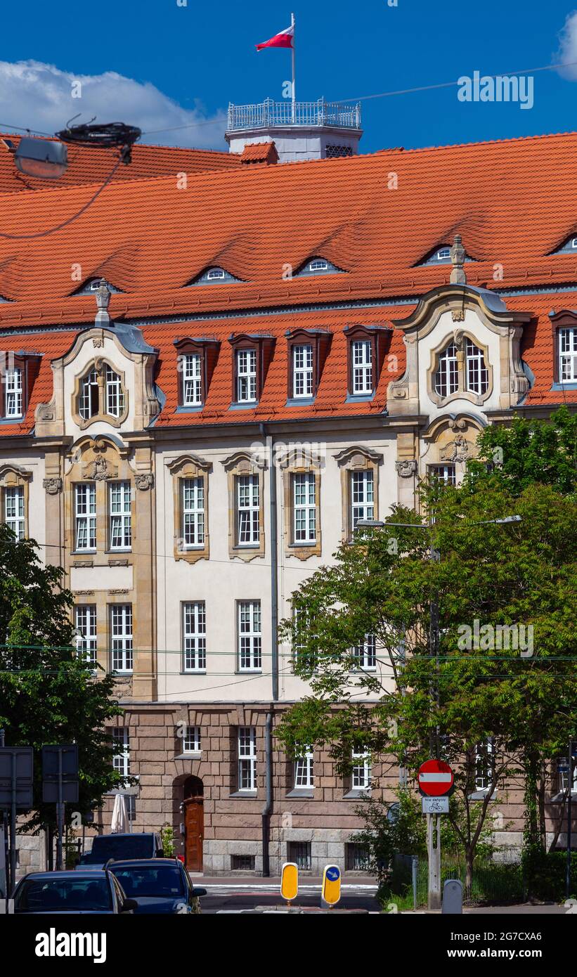 Waving Polish national flag on the dome of the building. Poland. Poznan. Stock Photo