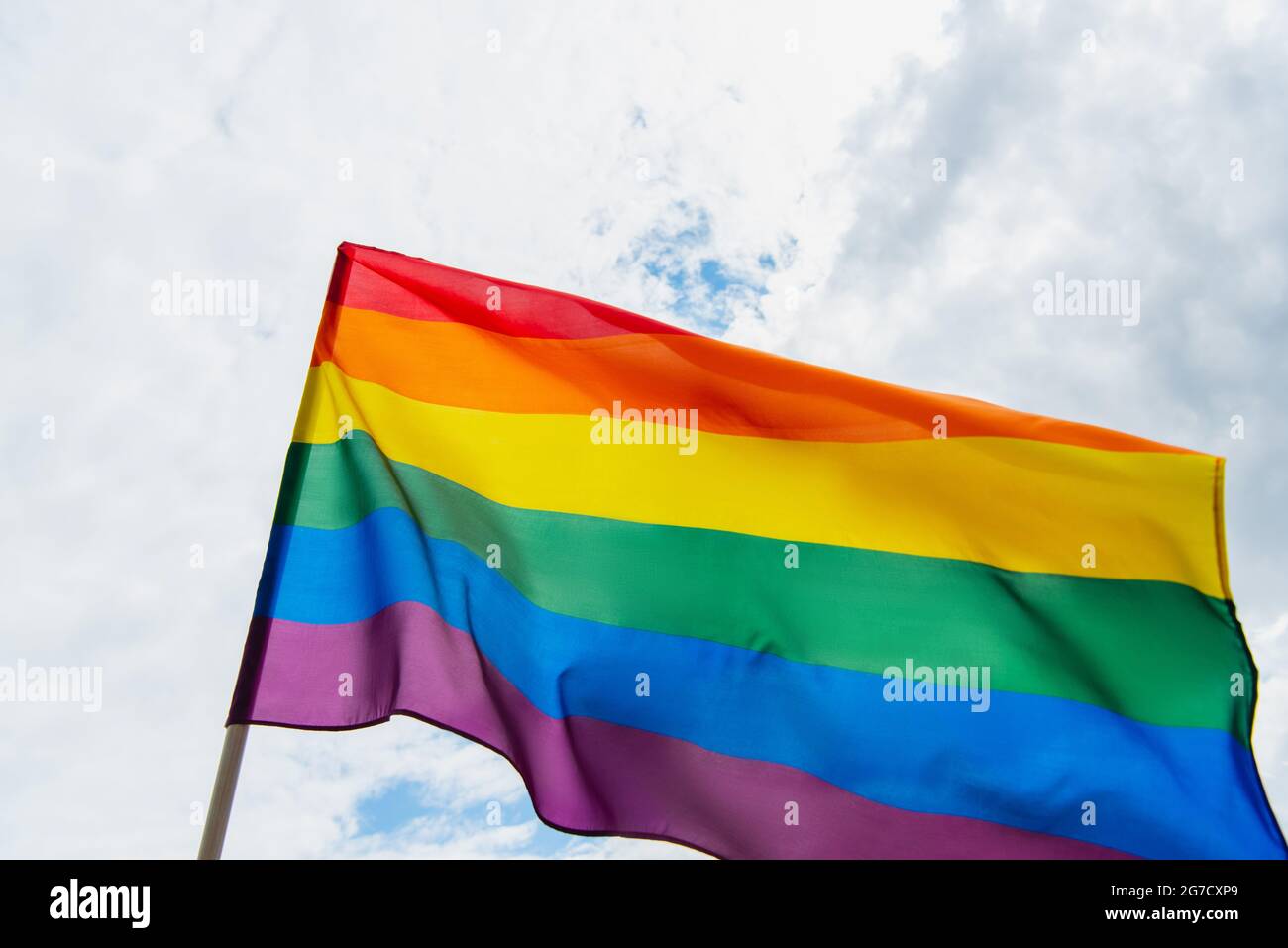 low angle view of colorful lgbt flag against sky with clouds Stock ...
