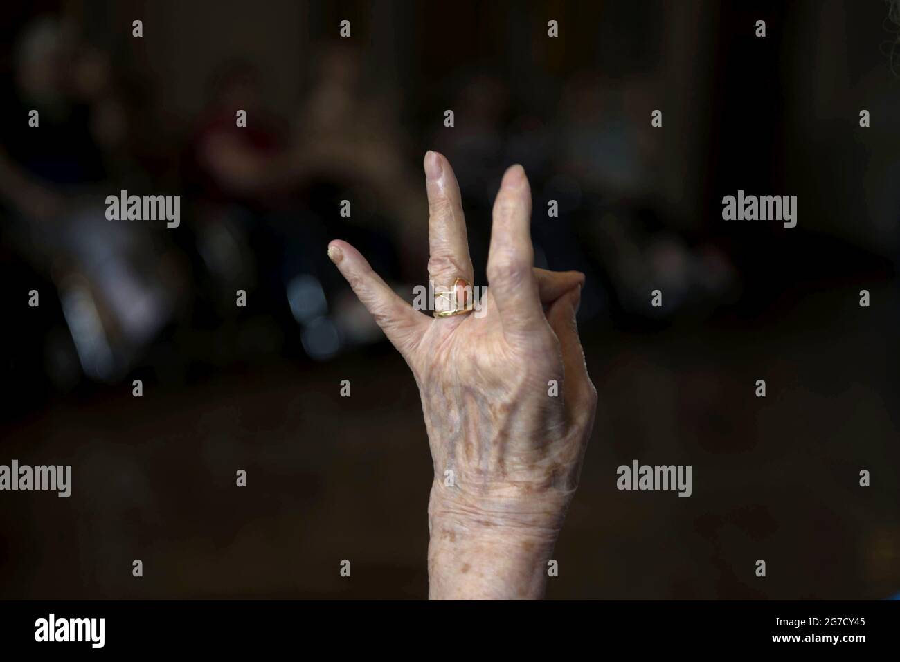 Hand's close up of centenary woman makes fingers exercises at the private retirement home, in Lentate sul Seveso, Milan, Italy. Stock Photo