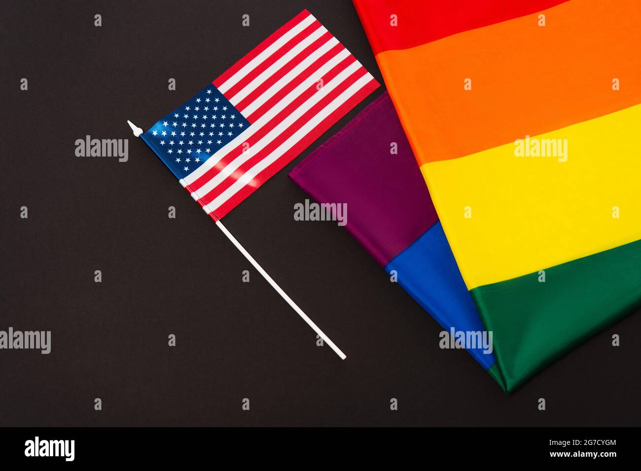 high angle view of american and lgbt flags isolated on black, equality ...