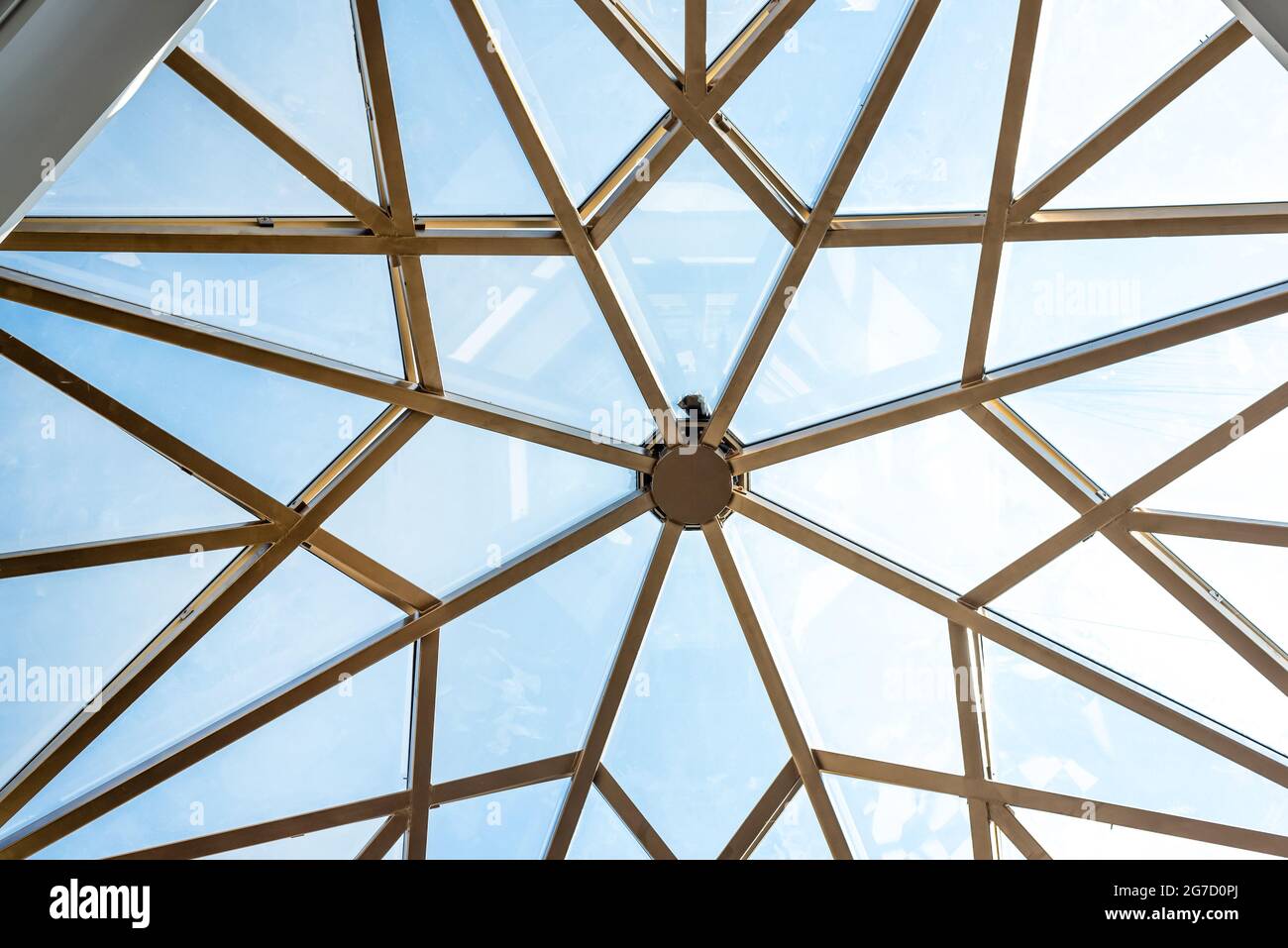 Clear blue sky bottom view through stylish glass ceiling Stock Photo