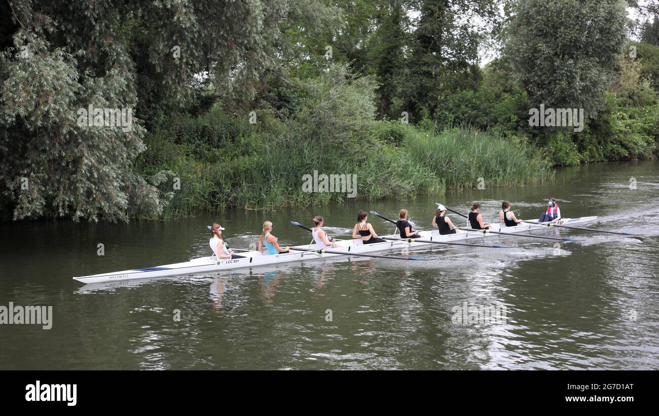 A team of all female boat crew rowing along the River Cam, Cambridge