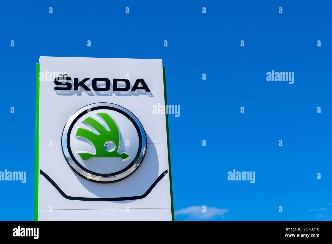 Tyumen, Russia-June 8, 2021: Facade of german car dealer with Skoda logo against clear cloudless blue sky Stock Photo