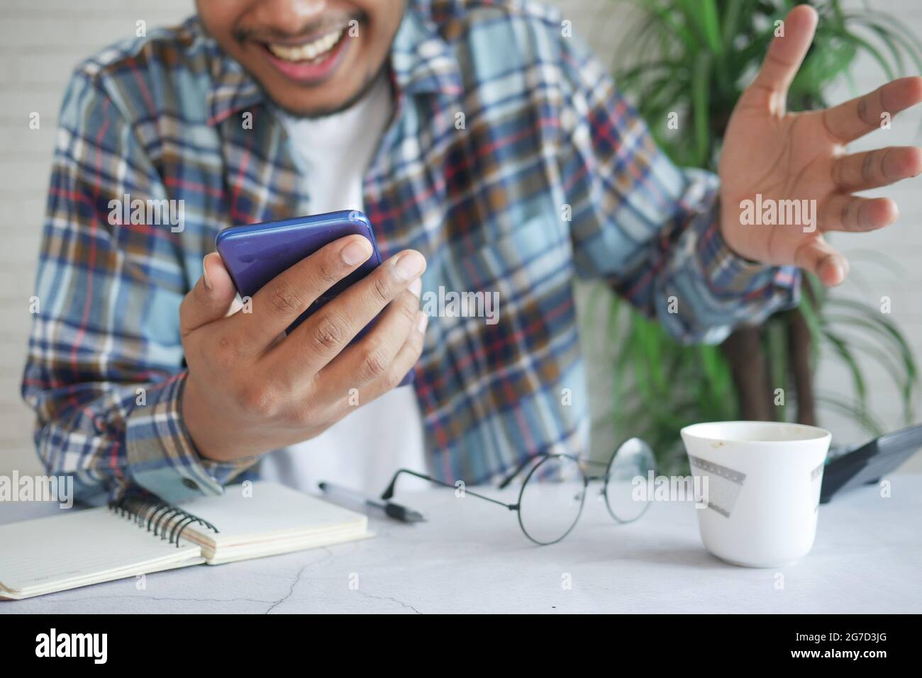 happy young man hand using smart phone. Stock Photo