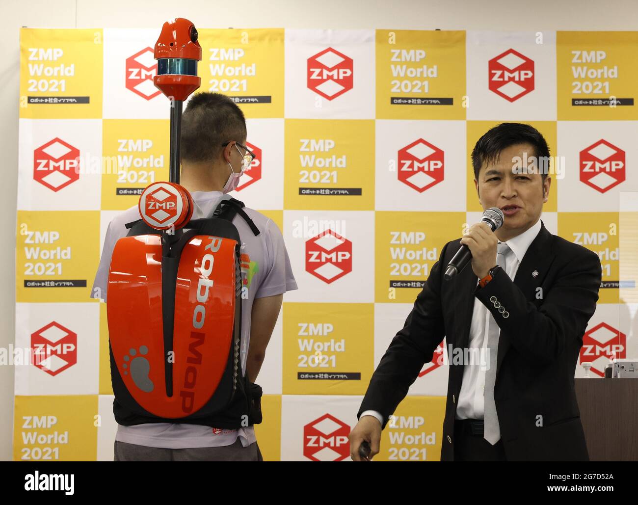 Tokyo, Japan. 13th July, 2021. Japan's robot venture ZMP employee displays  the portable mapping device RoboMap, a lightweight backpack with sensors of  3DLiDARs, gyro sensors and a camera to acquire 3D mapping