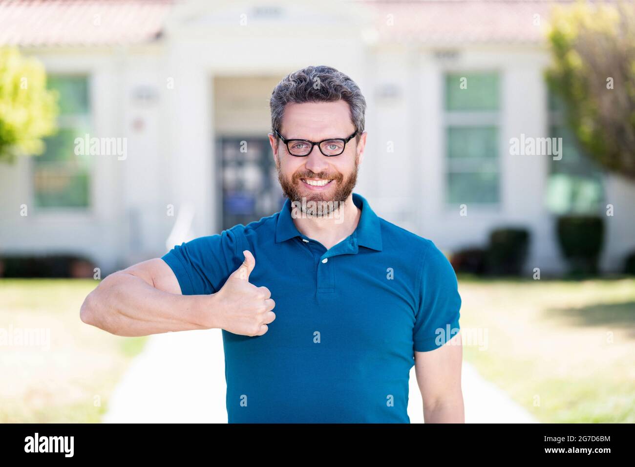 good eye health of happy guy in glasses with thumb up gesture, eye care Stock Photo