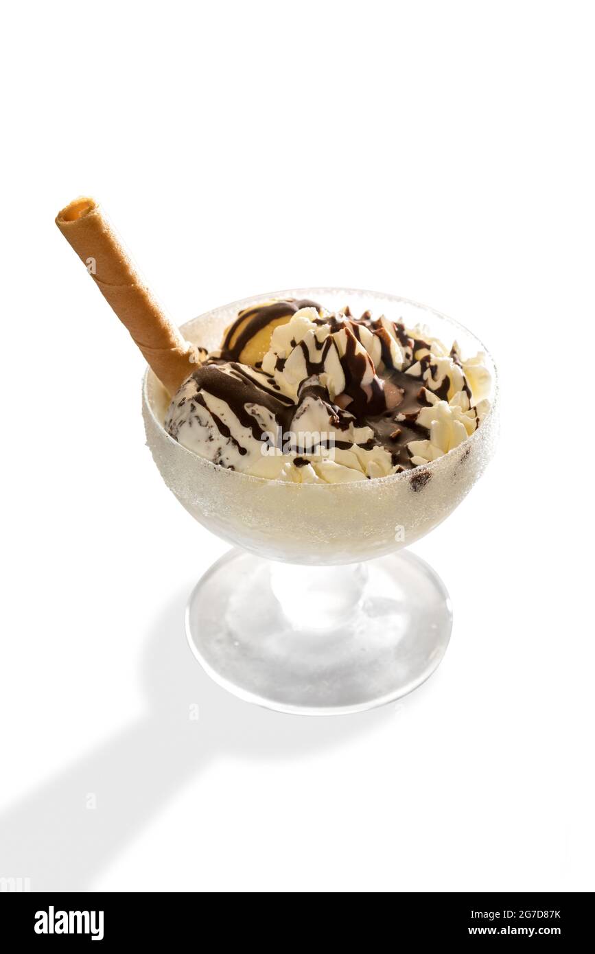 Ice cream with chocolate and wafer biscuit in glass cup isolated on