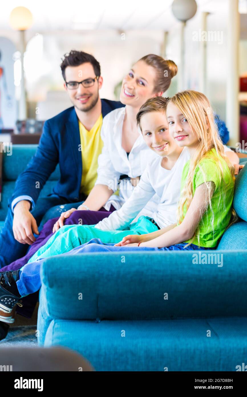 Family selecting together sofa in home-centre to furniture store Stock Photo