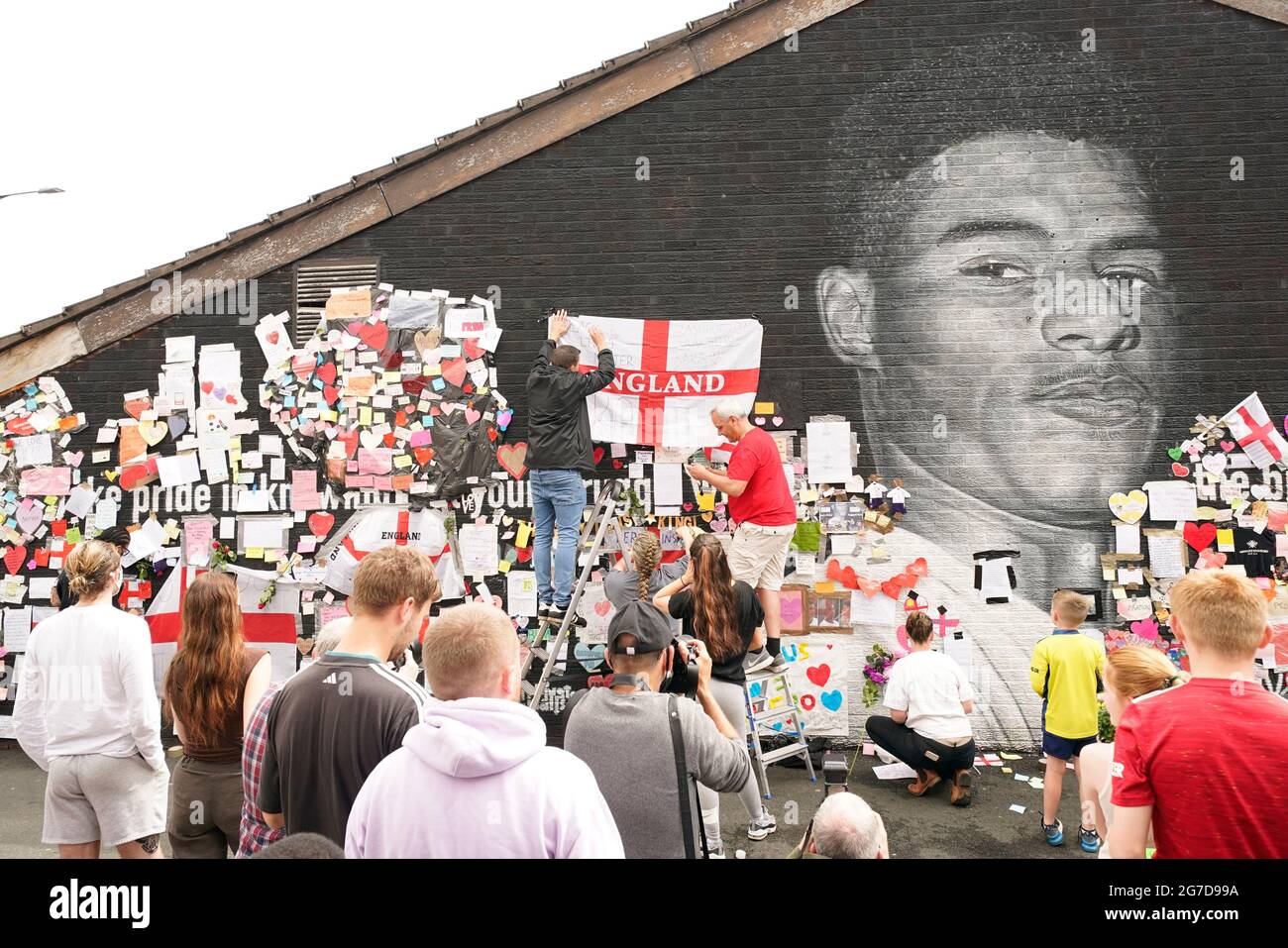 People put up flags and messages on the mural of Manchester United