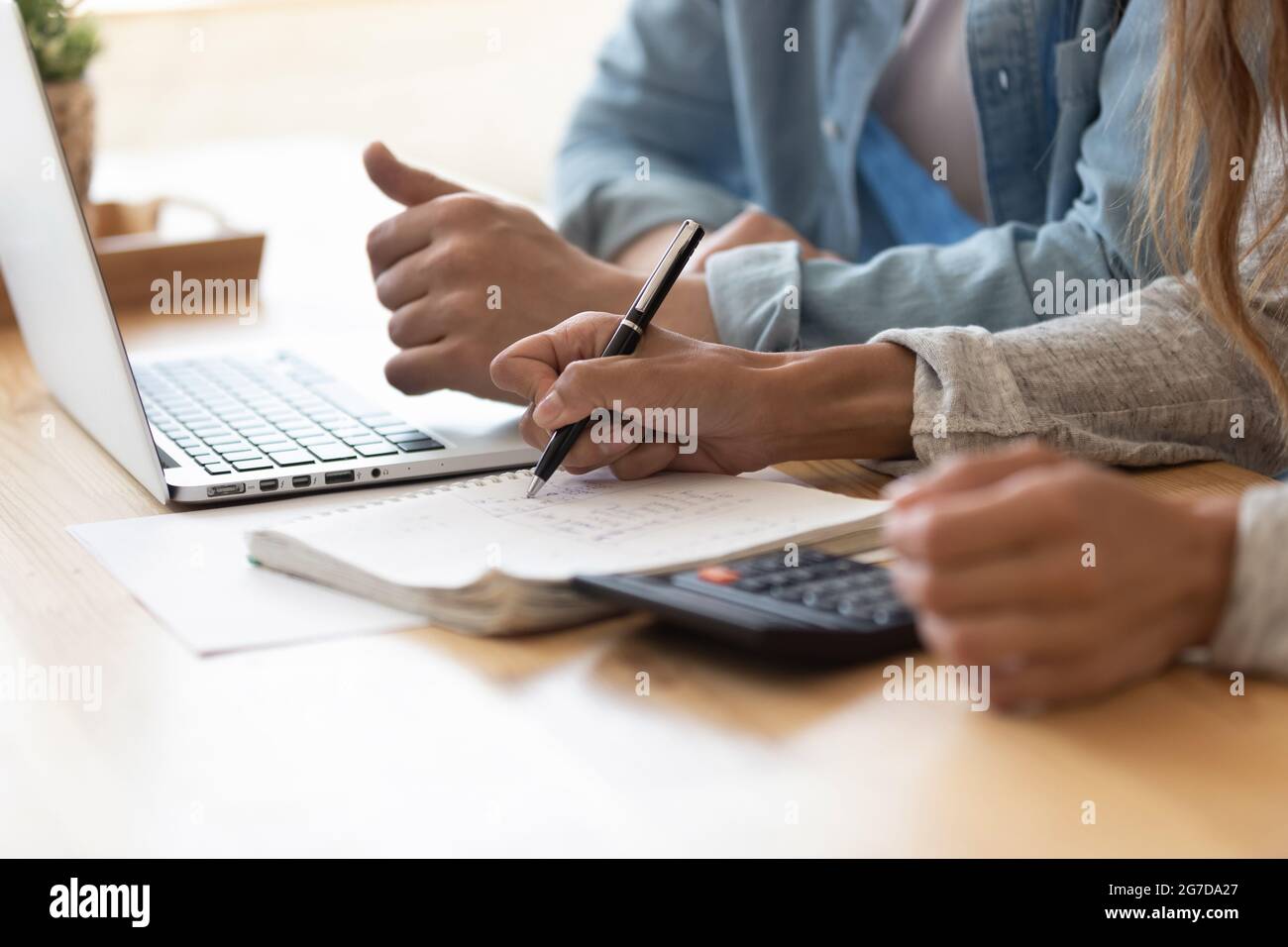 Close up spouses calculating family budget paying online using laptop Stock Photo