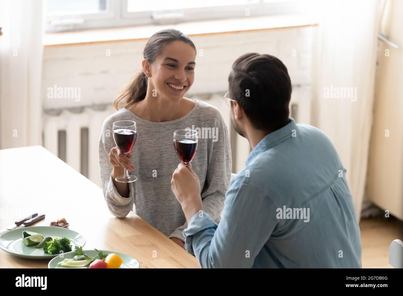 Husband makes a toast to wife during family holiday celebration Stock Photo