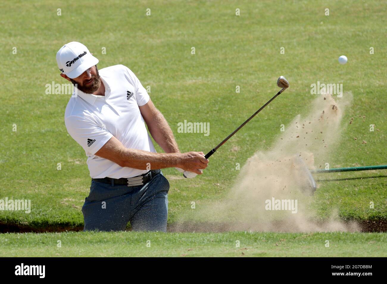 USA's Dustin Johnson chips out of a bunker on the 6th during the