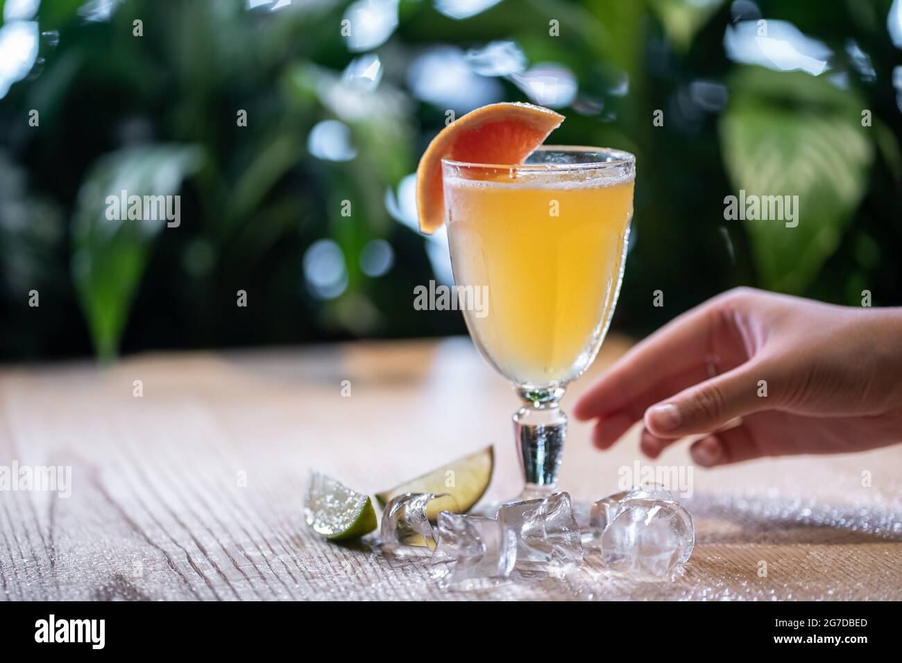 lemonade in glass or refreshing drink with grapefruit, lime and ice on table Stock Photo