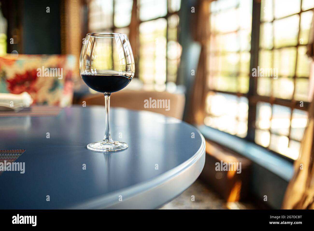 Glass of red wine on the restaurant table Stock Photo