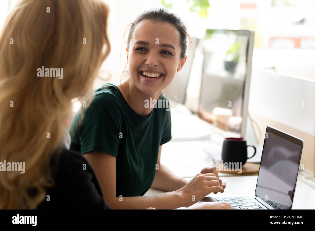 Happy millennial intern, student girl talking to teacher, consulting tutor, Stock Photo