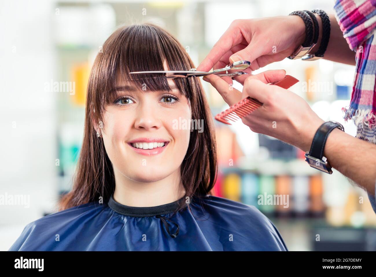 Hairdresser cutting woman bangs hair in shop Stock Photo Alamy