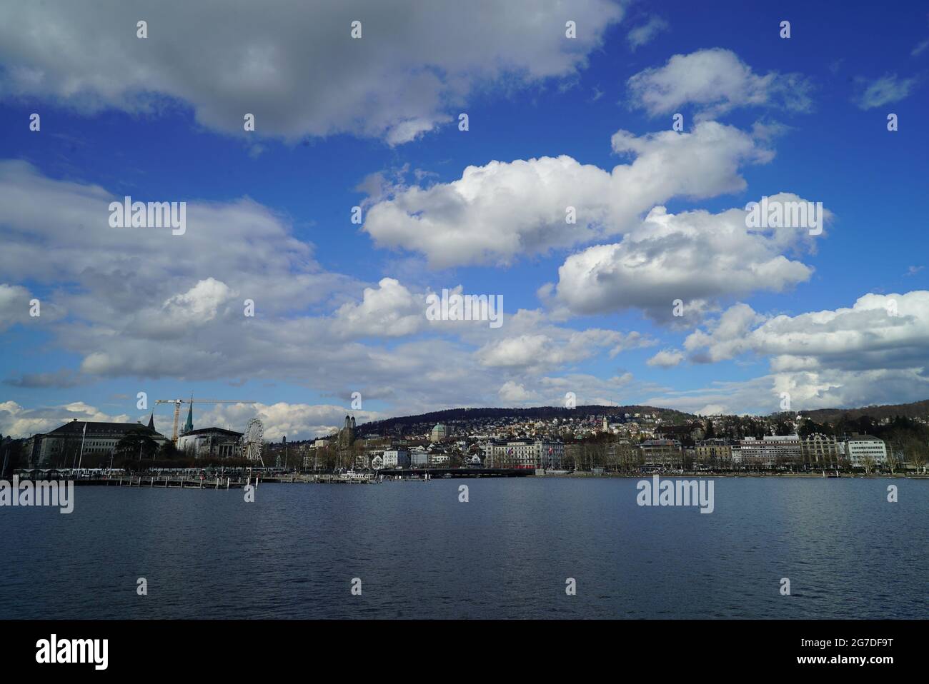 Landscape of a lake surrounded by a town under a blue cloudy sky Stock ...