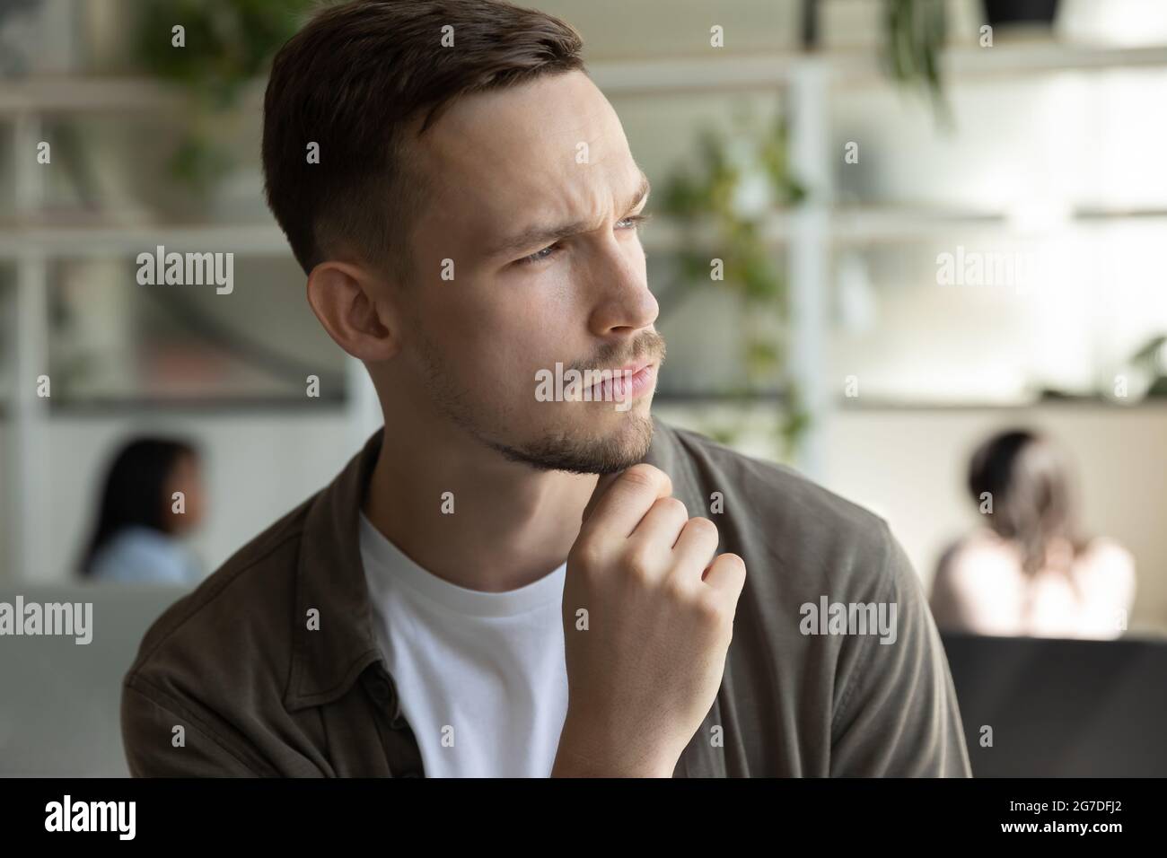Serious pensive young man, businessman looking at window away Stock Photo