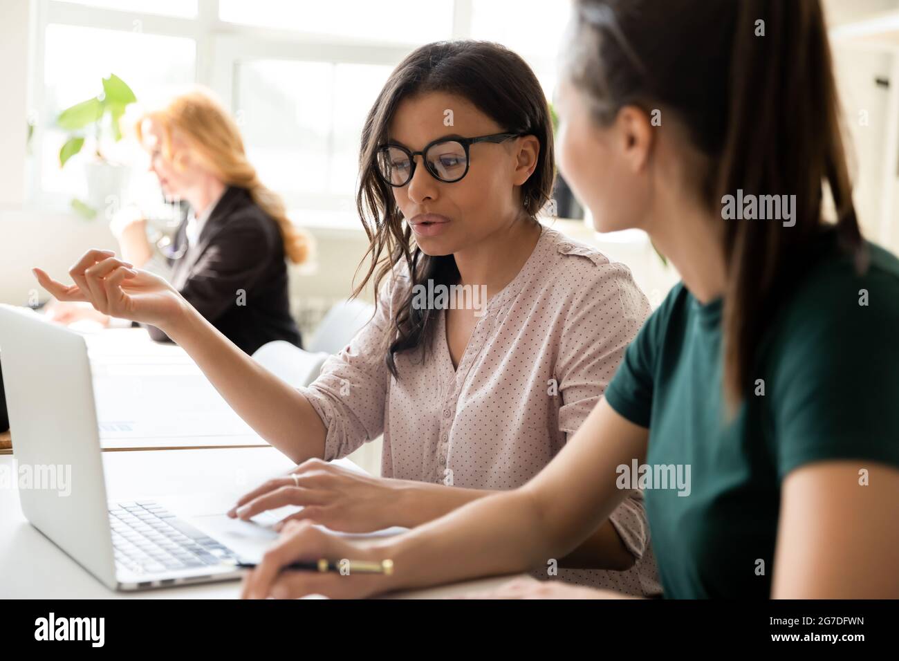 Serious diverse business team members discussing startup project Stock Photo