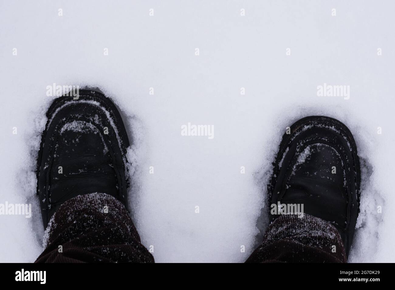 Feet in boots in white snow Stock Photo Alamy