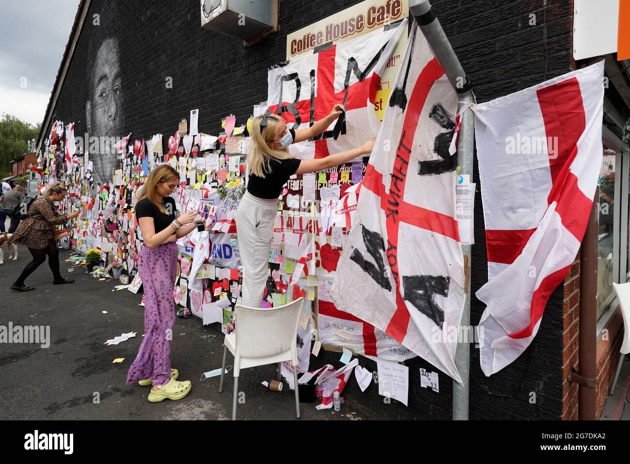 People put up flags and messages on the mural of Manchester United