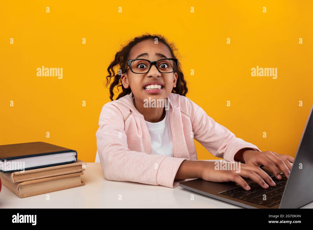 Shocked black girl using laptop and looking at camera Stock Photo