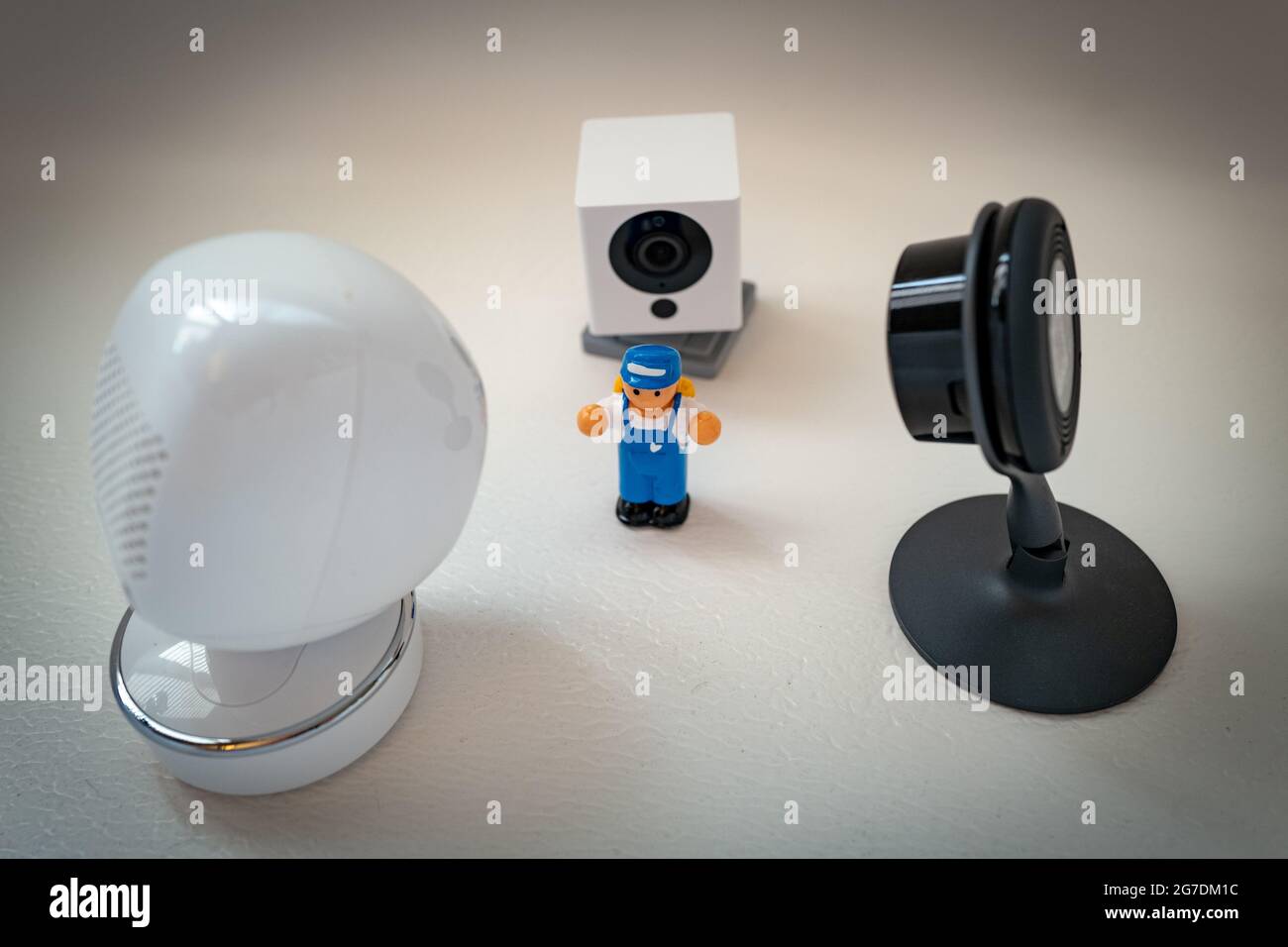 Illustrative image of a plastic child's toy person surrounded by security cameras from Google Nest, Simcam, and Wyze on a white background, suggesting mass surveillance, in San Ramon, California, November 20, 2020. () Stock Photo