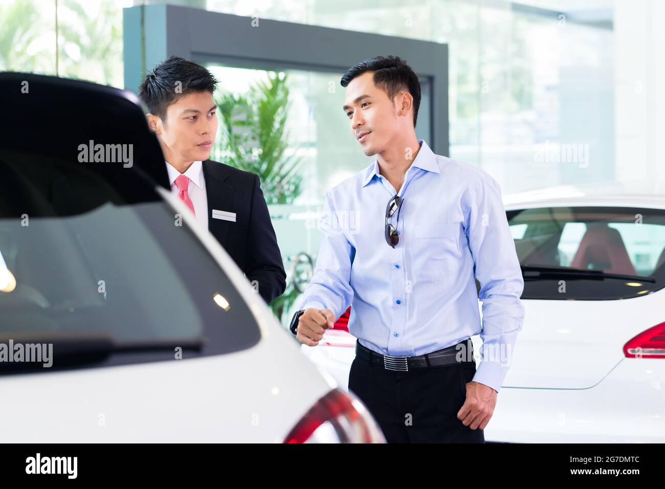Asian Car Salesman selling auto to customer Stock Photo Alamy