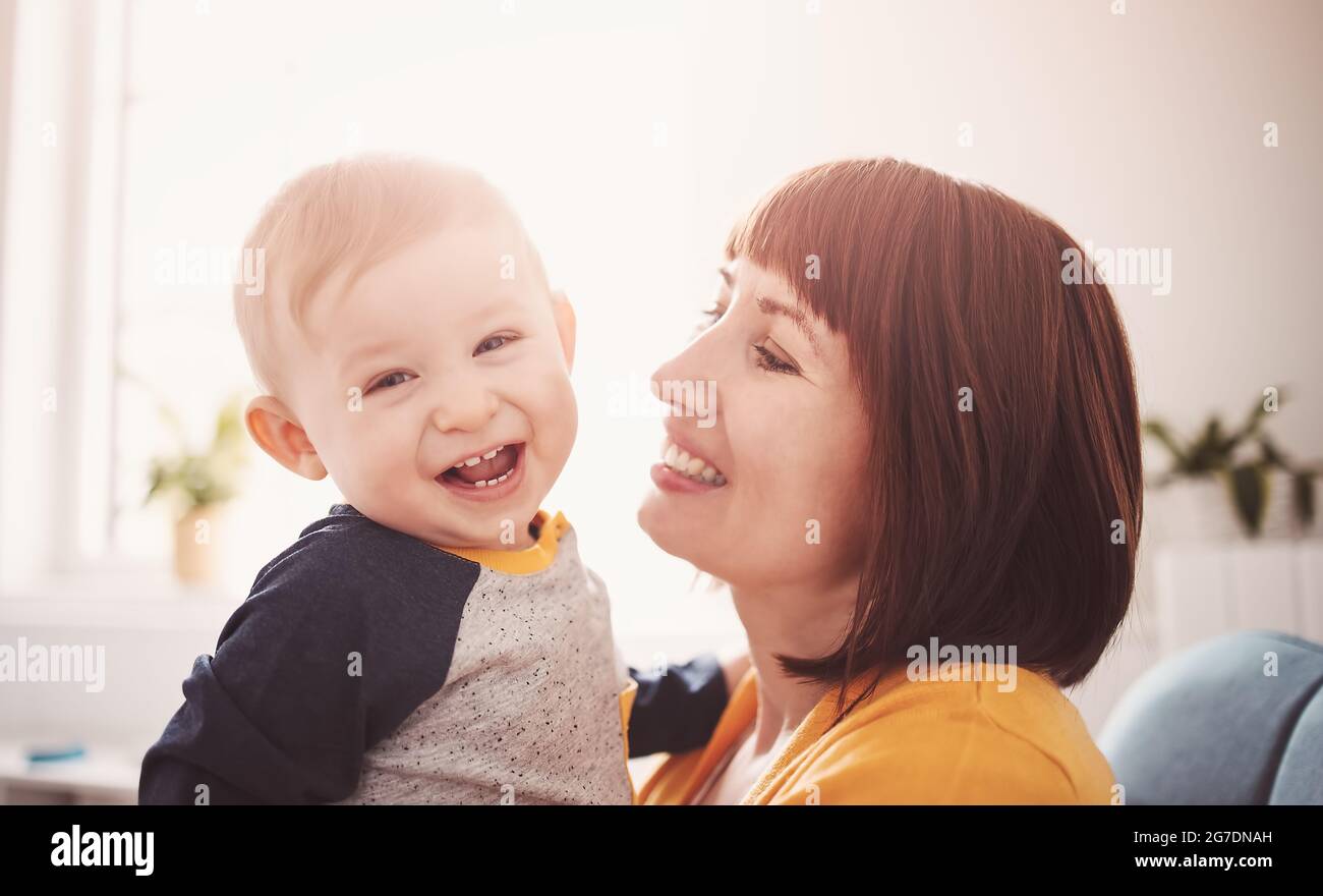 Happy mother holding in her arms her smiling son Stock Photo - Alamy
