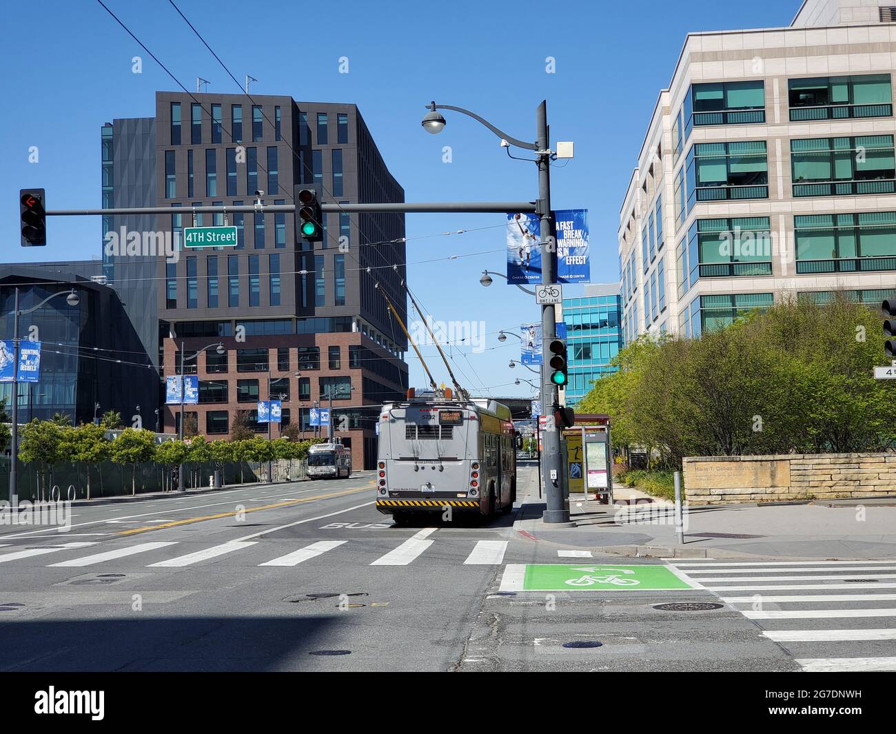 Back view of a bus going down 4th Street past the UCSF Medical Center at Mission Bay in San Francisco, California, April 18, 2021. () Stock Photo