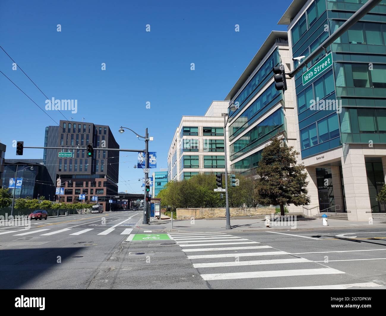 Eye-level view of a solitary, red sports car approaching the intersection of 16th Street and 4th Street near UCSF Benioff Children's Hospital in San Francisco, California, April 18, 2021. () Stock Photo