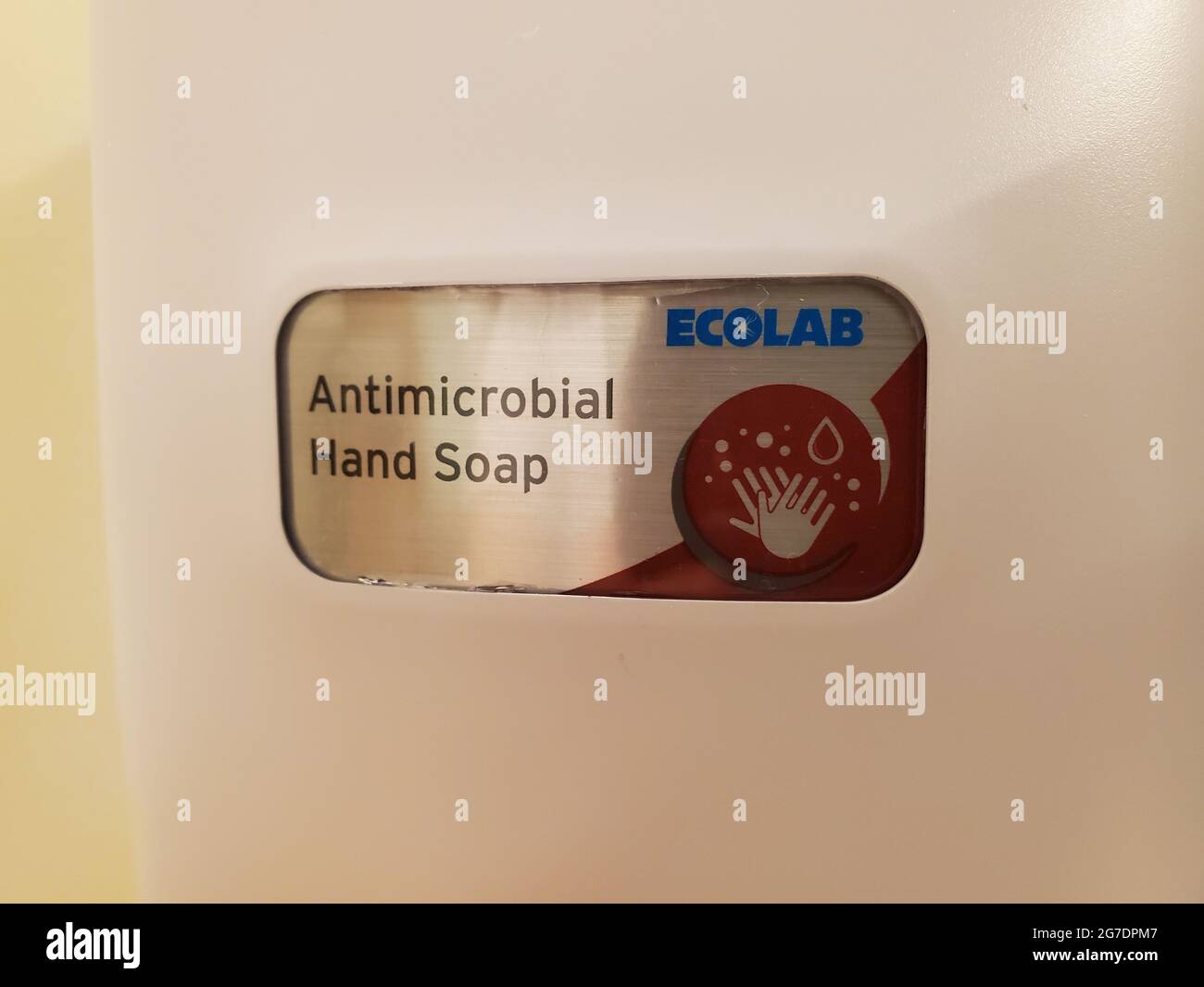 Closeup of an 'Ecolab Antimicrobial Hand Soap' logo on a wallmounted