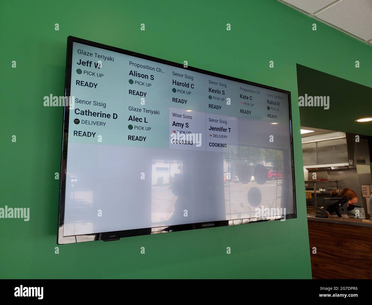 Side view of a digital panel showing order status from multiple restaurants, including Glaze Teriyaki, Senor Sisig, and Wise Sons at the Local Kitchens pickup and delivery in Lafayette, California, April 29, 2021. () Stock Photo
