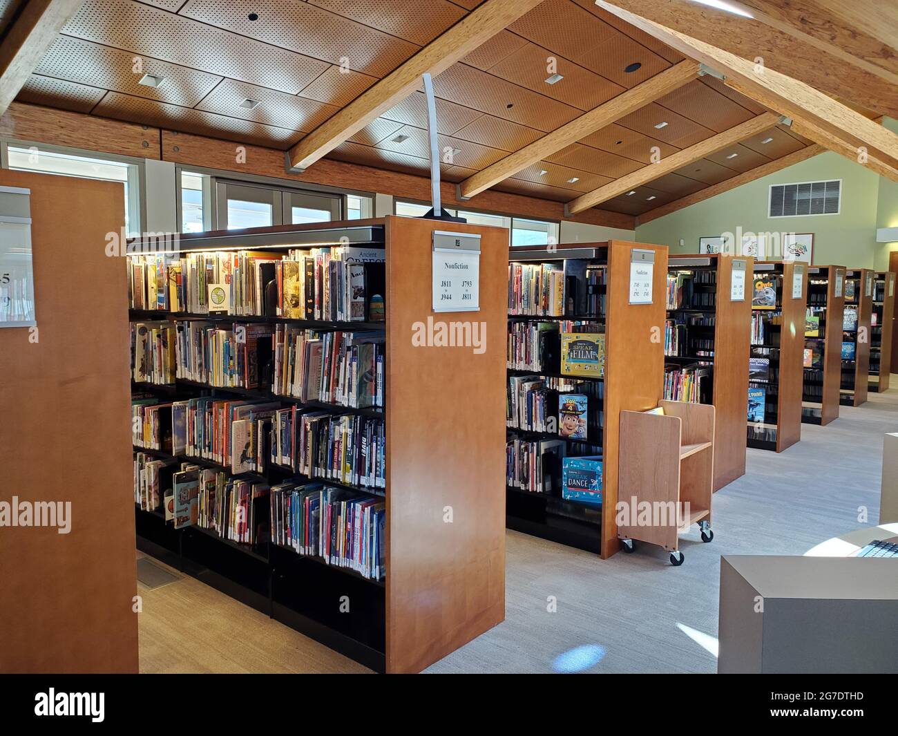 Stacks and shelves of books are visible at the Lafayette Public Library