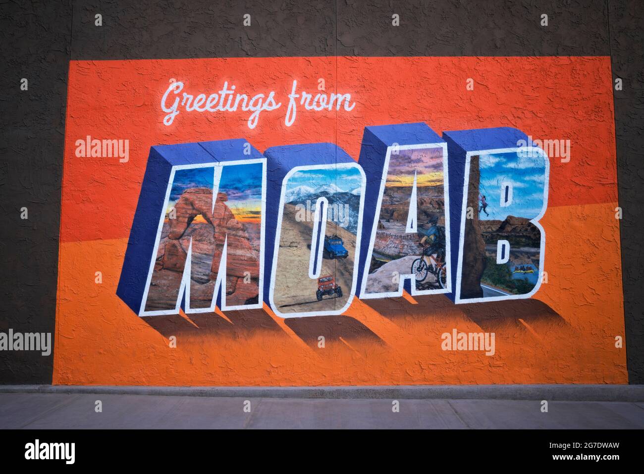 Large building size mural in Moab shows some of the many outdoor activites that draw visitors from around the world to this area of Utah. Stock Photo