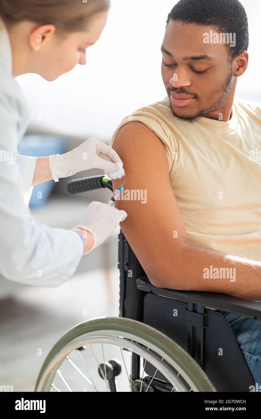 Doctor giving injection shot in hi-res stock photography and images - Alamy