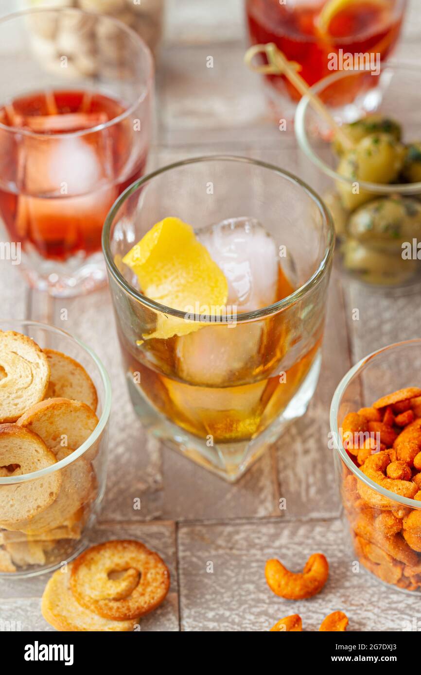 Alcoholic drinks, cocktails on ice and salty snack, appetizers Stock