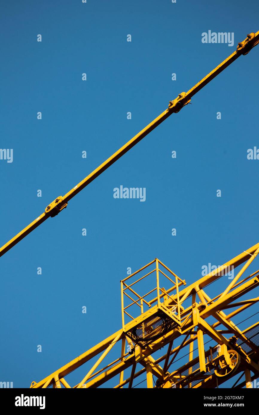yellow crane on a blue background Stock Photo - Alamy