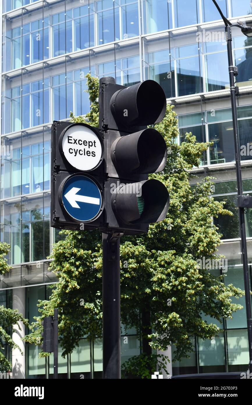 Green light on traffic lights with a left right of way excluding cycles on a street in London Stock Photo