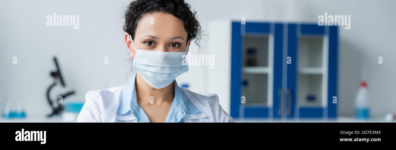 African american doctor in medical mask looking at camera in hospital ...