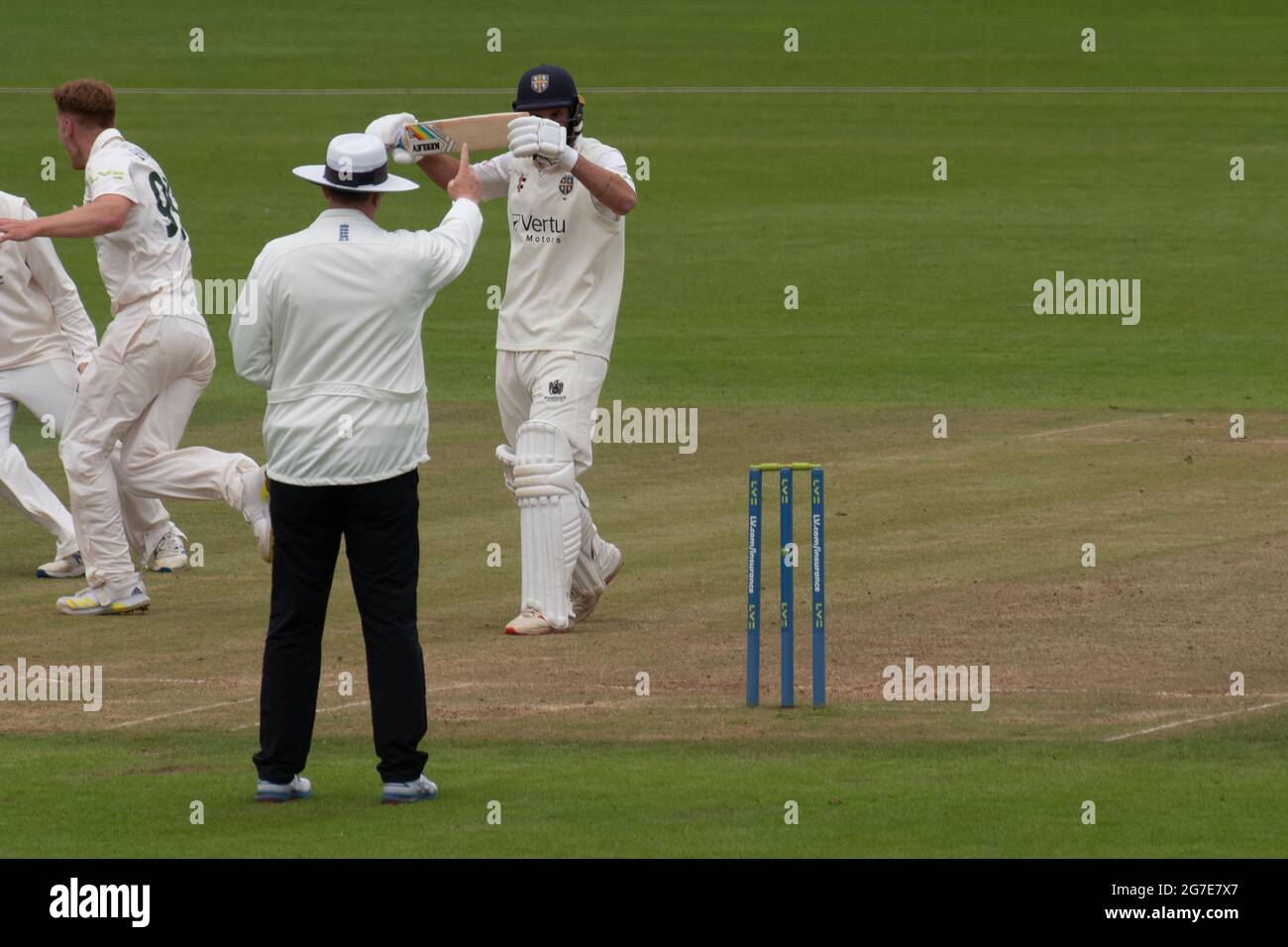 Chester le Street, England, 13 July 2021. Ned Eckersley of Durham Cricket holding his bat in the air after being given out LBW by umpire Neil Pratt during their county championship match against Nottinghamshire at the Riverside Ground Chester le Street. Credit: Colin Edwards/Alamy Live News. Stock Photo