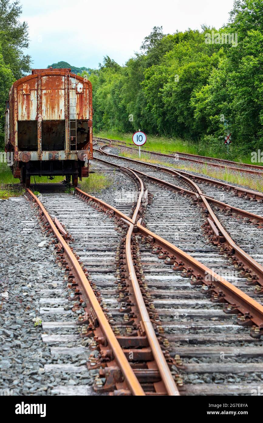 abandoned railway carriage at a junction and with rail track intersections, Ayrshire, Scotland Stock Photo