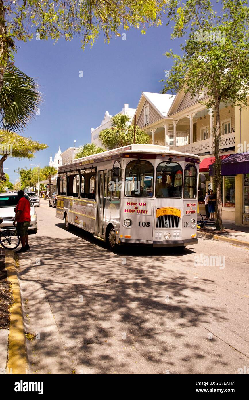 Hop on Hop off Bus trolley for sightseeing in Key West, driving along Duval Street, the main shopping location in Key West, Florida Stock Photo