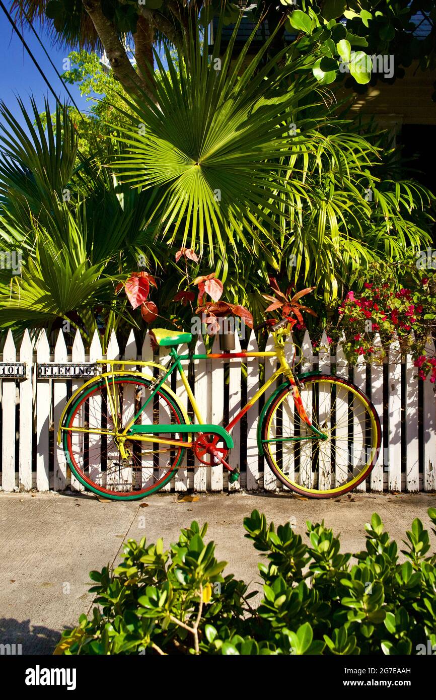 Bicycle on white picket fence Key West, Florida, FL USA.  Southern most point in the continental USA.  Island vacation destination. Stock Photo