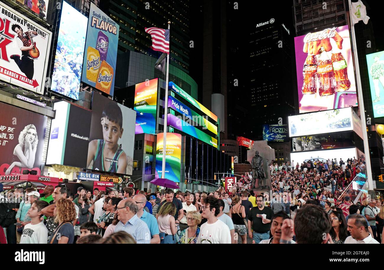 Tourists gathering at night in Times Square, Manhattan, New York City. Stock Photo