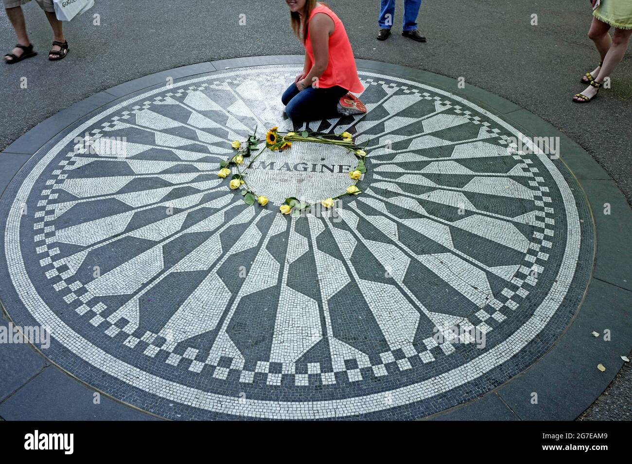 Tourists pay tribute to John Lennon at Strawberry Fields memorial, in Central Park, in New York City. Stock Photo