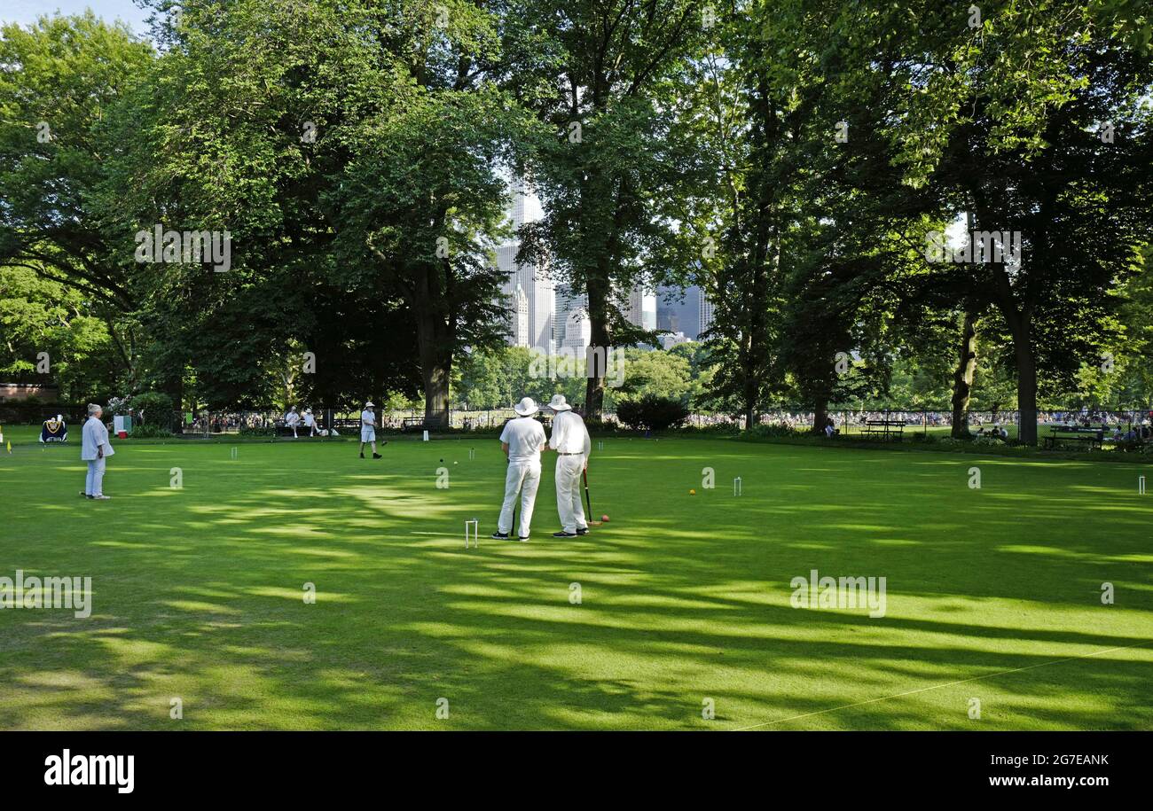 People playing cricket at Central Park on an hot summer saturday afternoon, in New York City. Stock Photo