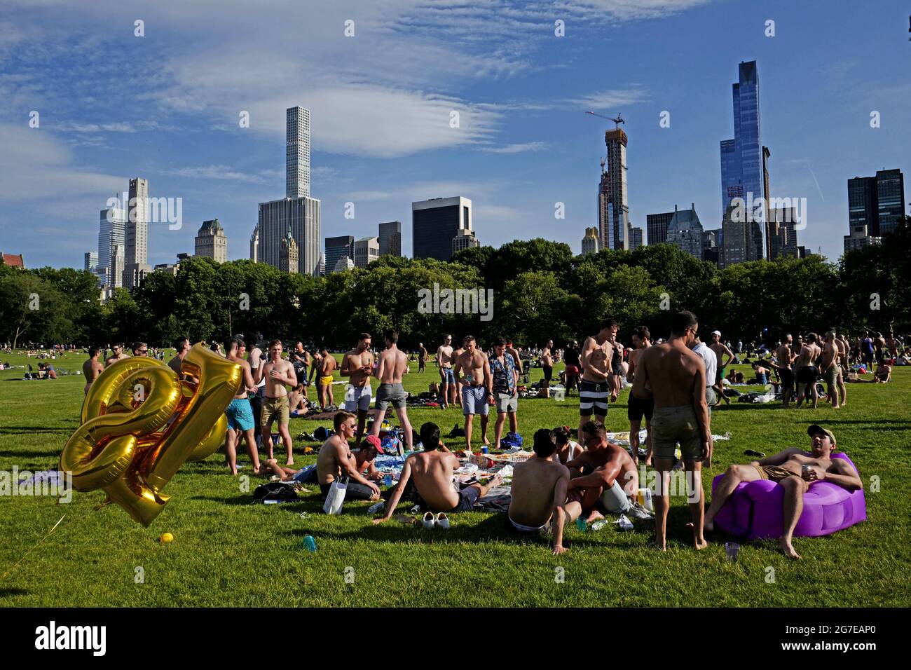 Swimsuit guys gathering at Central Park on an hot summer saturday afternoon, in New York City. Stock Photo