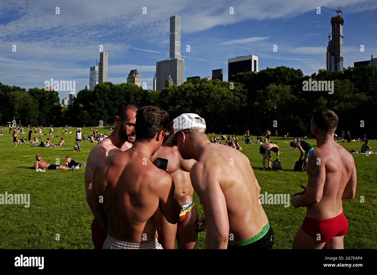 Swimsuit guys gathering at Central Park on an hot summer saturday afternoon, in New York City. Stock Photo