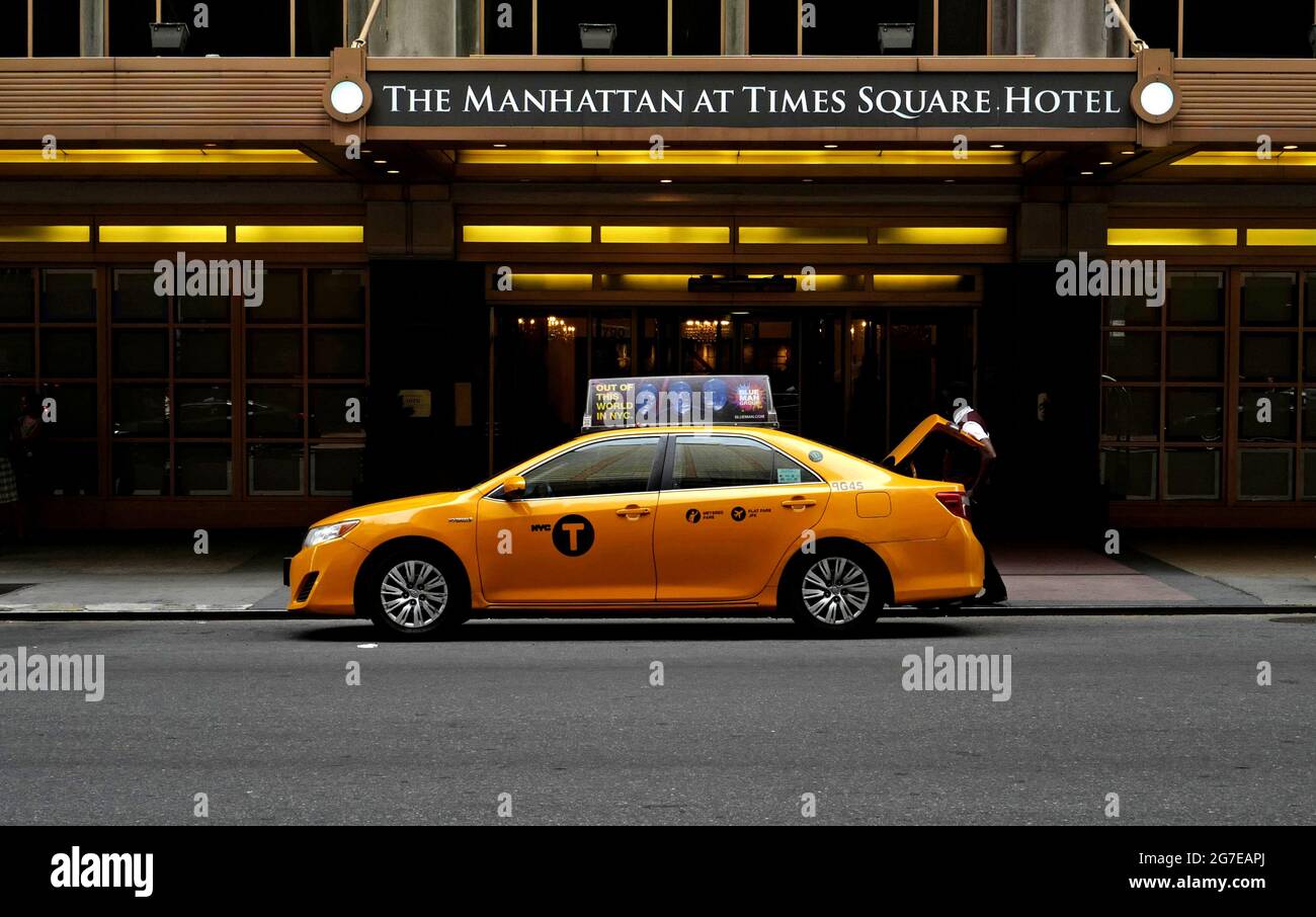NYC yellow cab in front of The Manhattan at Times Square Hotel, in Manhattan, in New York City. Stock Photo